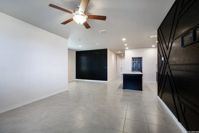 an empty room with projector and fan