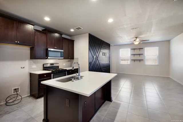a kitchen with a sink appliances and cabinets