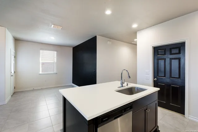 a kitchen with stainless steel appliances a sink and a refrigerator