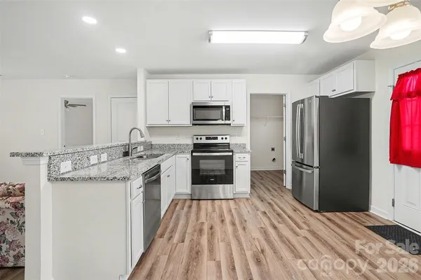 a kitchen with a sink stove and refrigerator