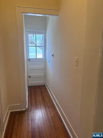a view of a room with wooden floor and window