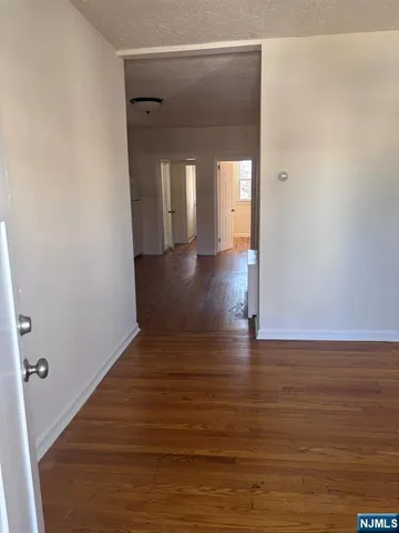 a view of a room with wooden floor