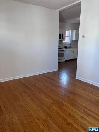 a view of a kitchen and wooden floor