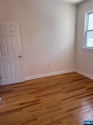 a view of wooden floor and cabinet in a room