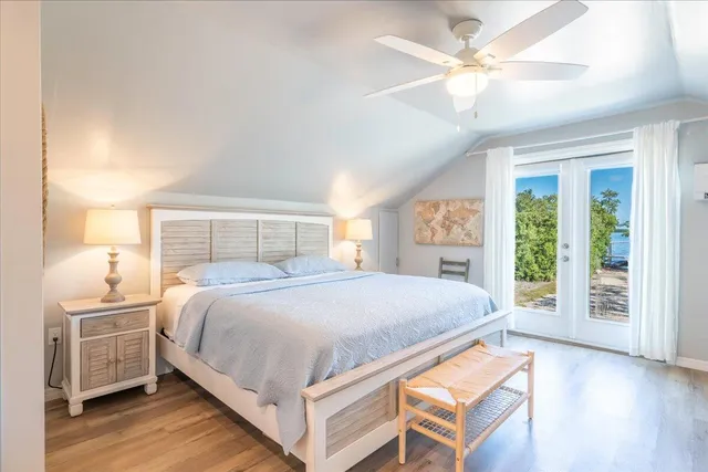 a bedroom with a large bed and a chandelier