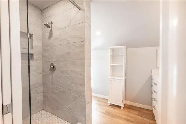 a bathroom with a glass shower door