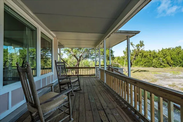 a view of a porch with furniture and wooden floor