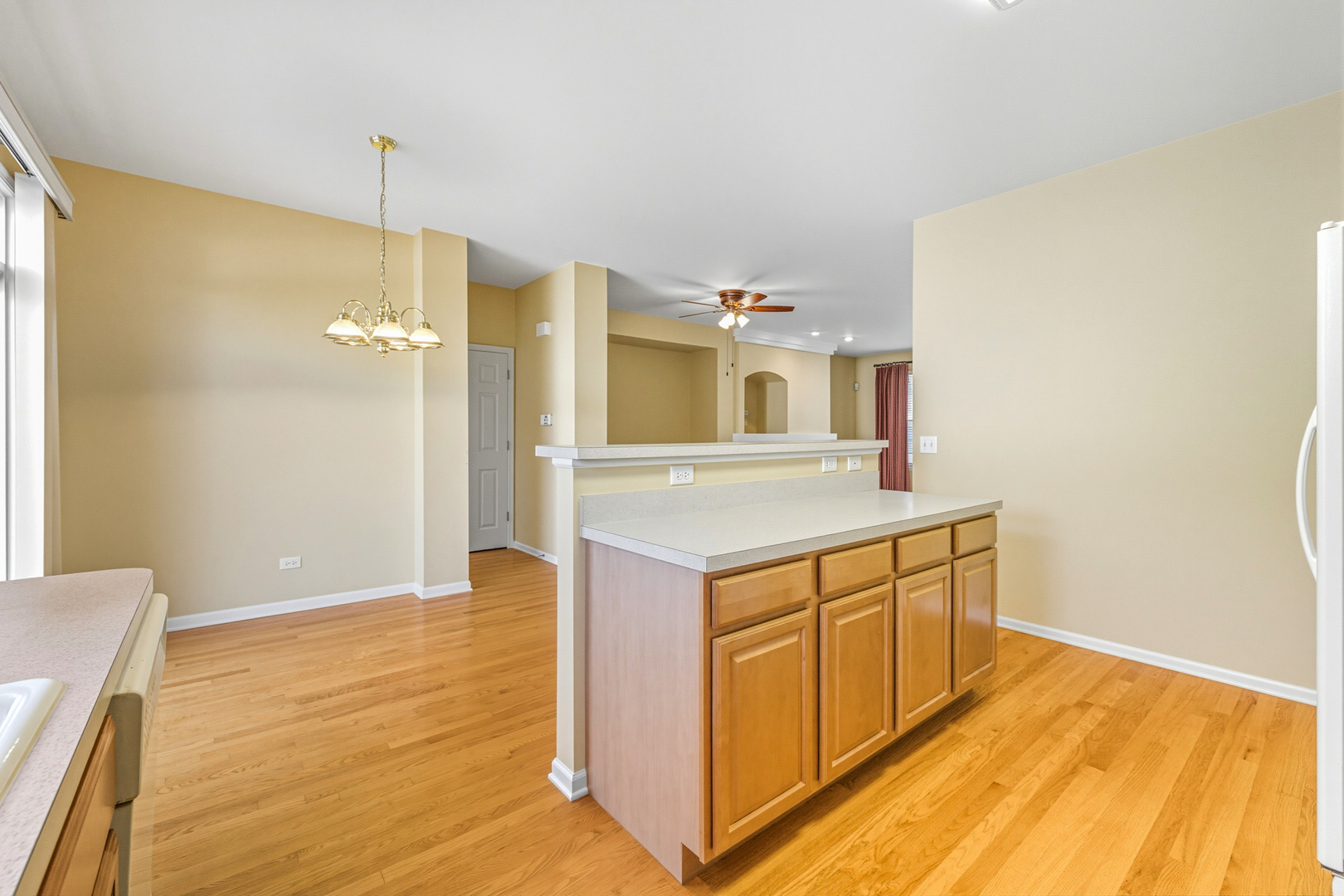 5662 Cambridge Way Hanover Park, IL 60133 - Photo 14 of 34 a kitchen with stainless steel appliances granite countertop a sink a stove a refrigerator and white cabinets with wooden floor