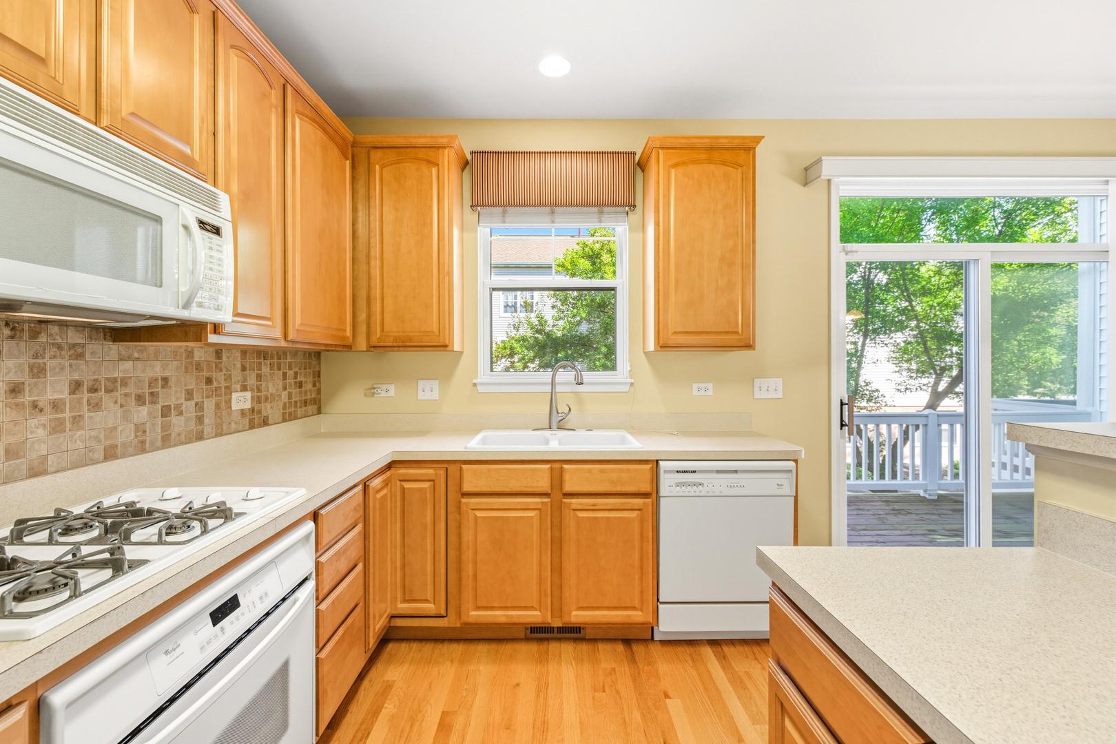 5662 Cambridge Way Hanover Park, IL 60133 - Photo 15 of 34 a kitchen with a sink stove and cabinets