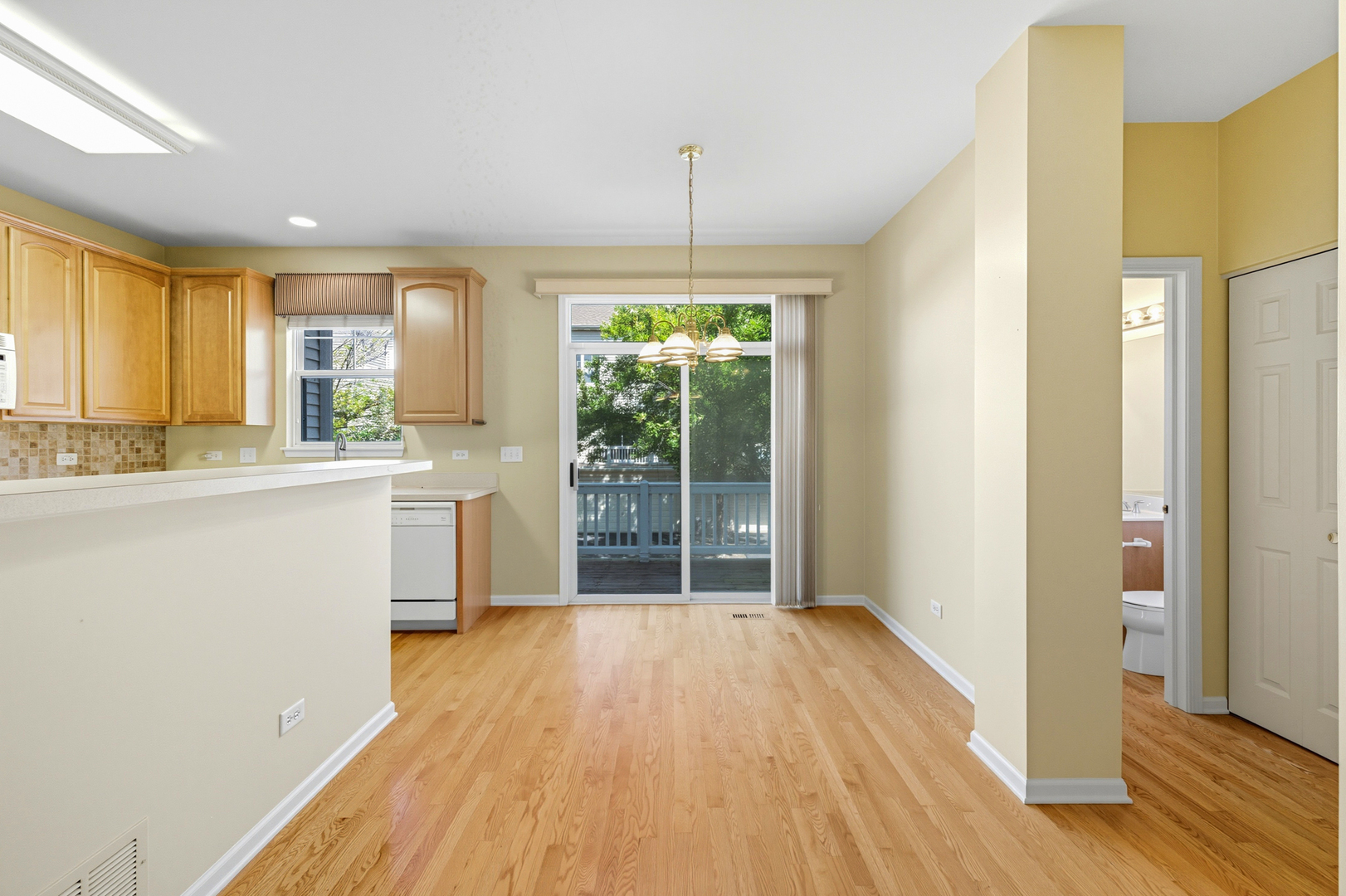 5662 Cambridge Way Hanover Park, IL 60133 - Photo 16 of 34 a view of a kitchen with a sink and dishwasher with wooden floor