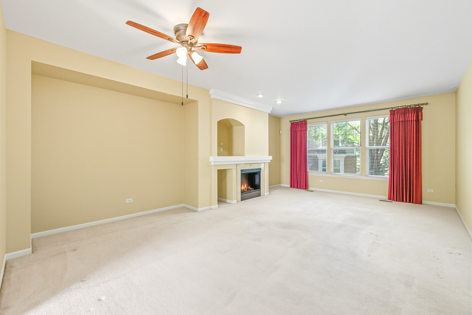 5662 Cambridge Way Hanover Park, IL 60133 - Photo 6 of 34 a view of an empty room with a fireplace and a window
