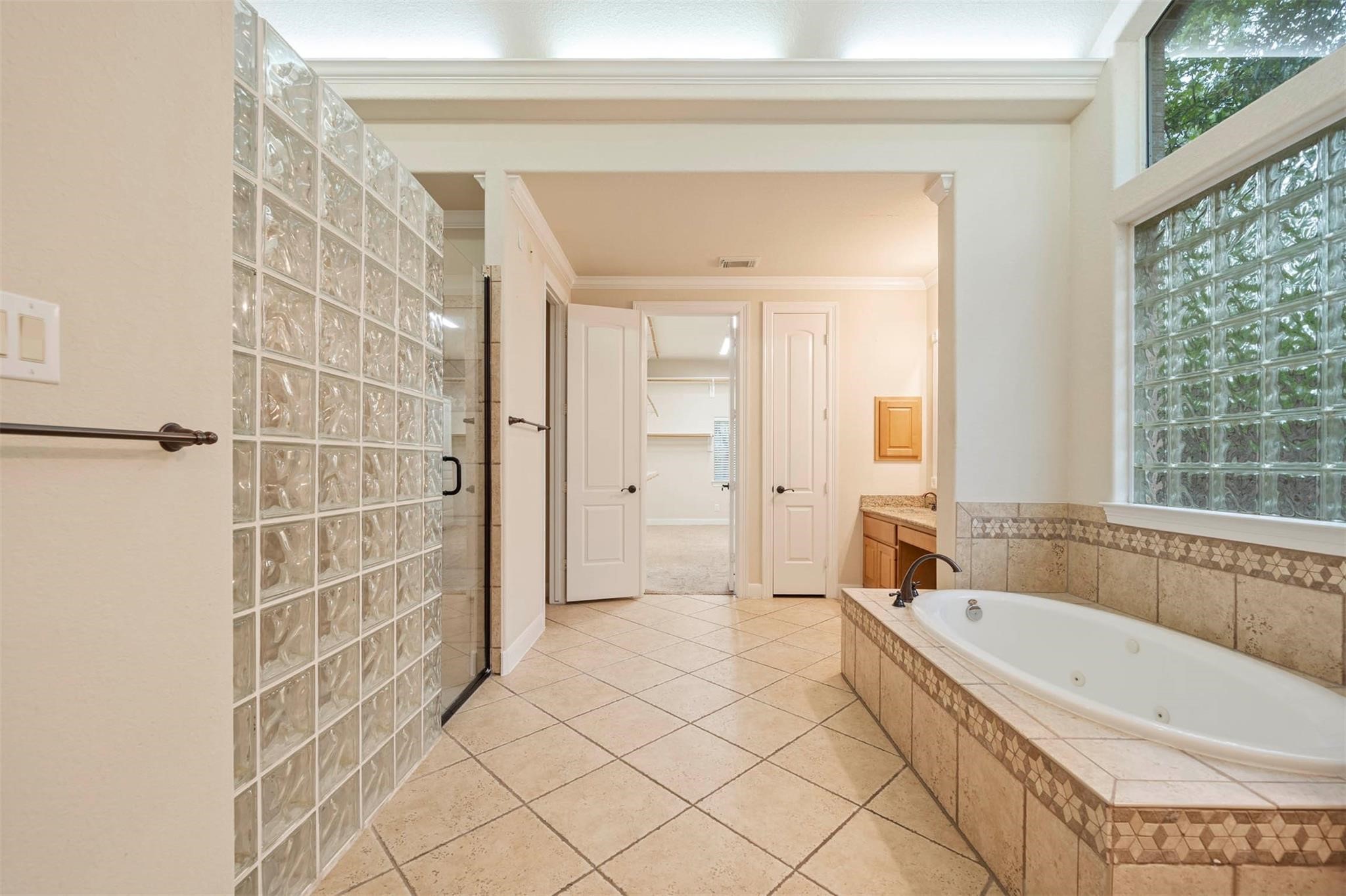 3 Etude Court Spring, TX 77382 - Photo 20 of 45 a bathroom with a bathtub and a shower
