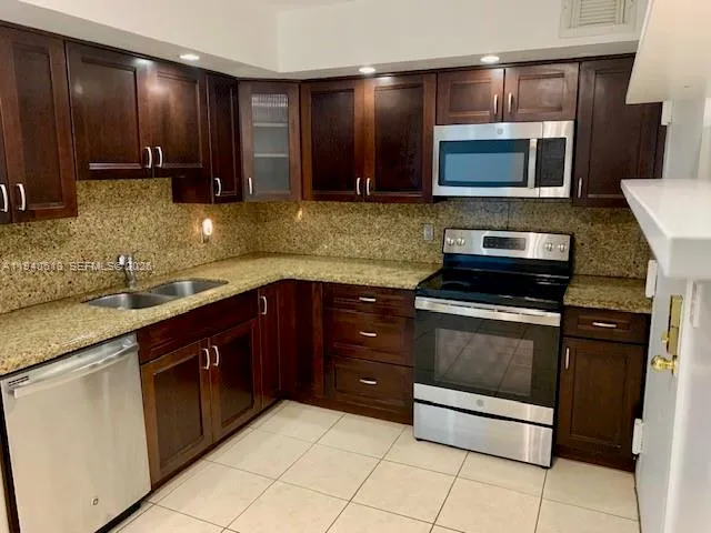 a kitchen with a sink and a stove top oven