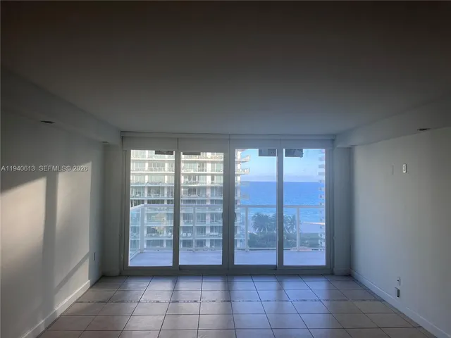 a view of an empty room with windows