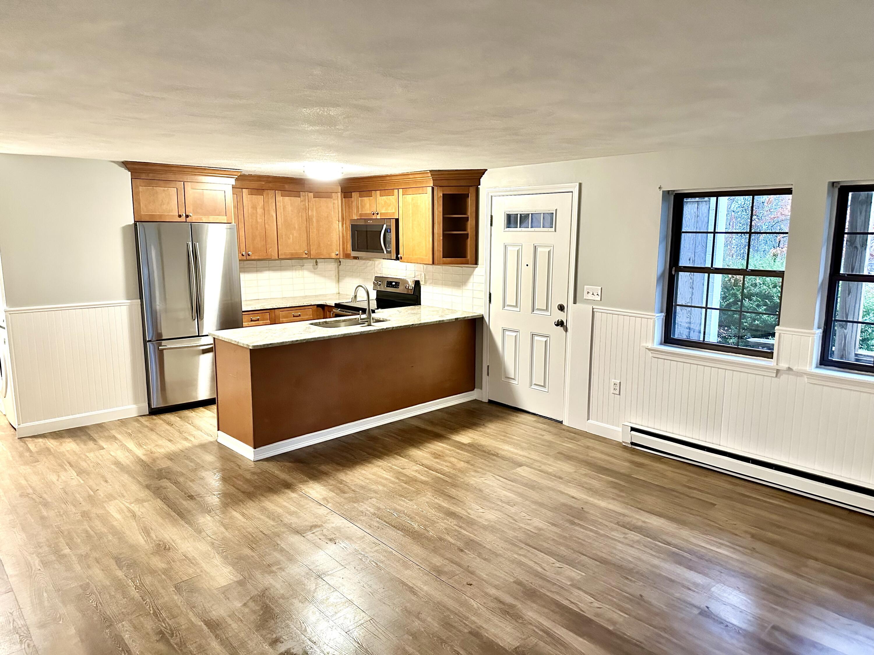 35 Ashumet Road, Unit 10B Mashpee, MA 02649 - Photo 3 of 7 a view of a kitchen with wooden floor and electronic appliances