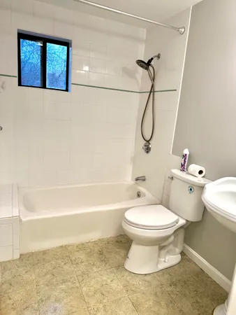a bathroom with a toilet and a shower