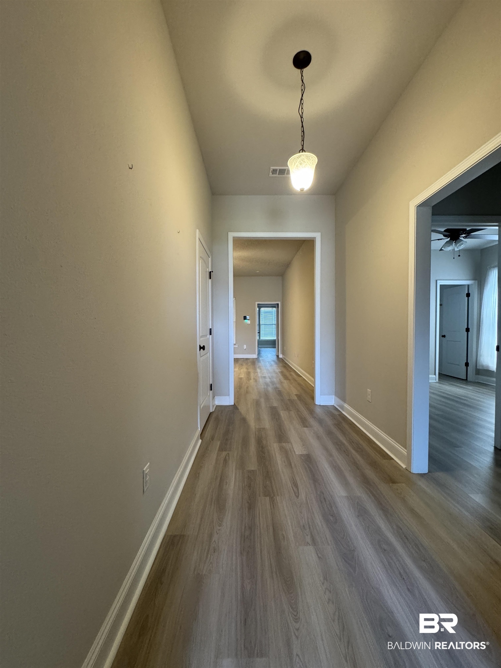 1060 Chloe Street Foley, AL 36535 - Photo 17 of 28 Entryway featuring wood-finish flooring, neutral wall tones, and white trim