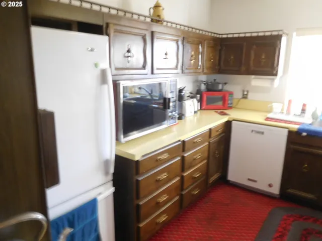 a kitchen with stainless steel appliances a sink and a refrigerator