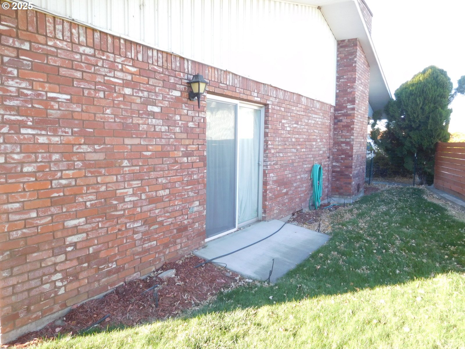117 North Main Street Milton Freewater, OR 97862 - Photo 2 of 21 a view of backyard with brick wall and plants