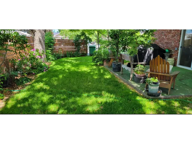 a backyard of a house with table and chairs