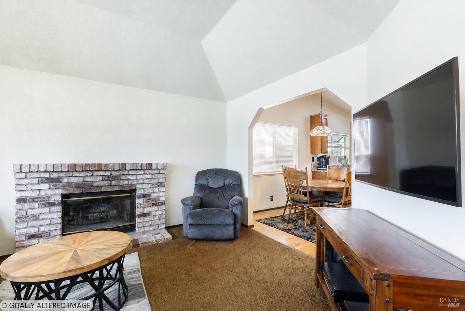 1935 Seville Street Santa Rosa, CA 95403 - Photo 4 of 30 a living room with furniture a flat screen tv and a fireplace