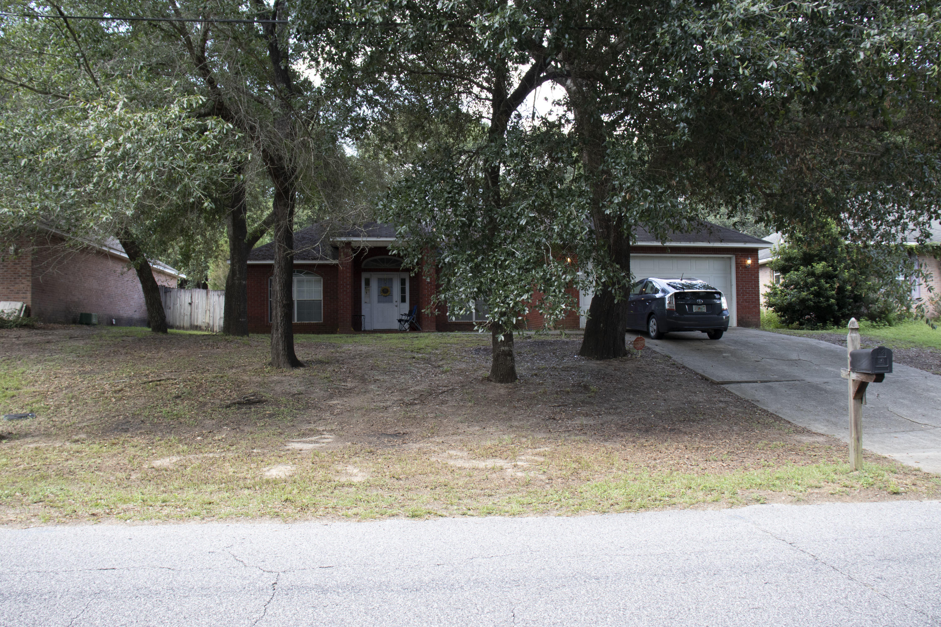 a view of house with outdoor space and parking