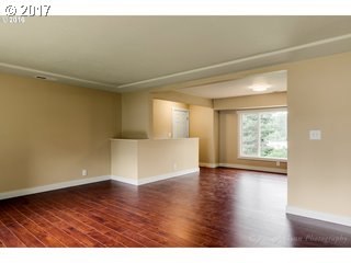 13240 Southeast Rusk Road Milwaukie, OR 97222 - Photo 11 of 24 a view of an empty room with wooden floor and a window