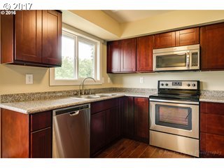 13240 Southeast Rusk Road Milwaukie, OR 97222 - Photo 3 of 24 a kitchen with granite countertop cabinets stainless steel appliances and a window