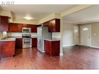 13240 Southeast Rusk Road Milwaukie, OR 97222 - Photo 4 of 24 a kitchen with stainless steel appliances granite countertop a refrigerator microwave and sink