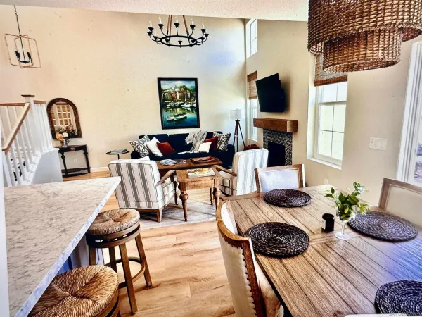 a living room with lots of furniture and kitchen view