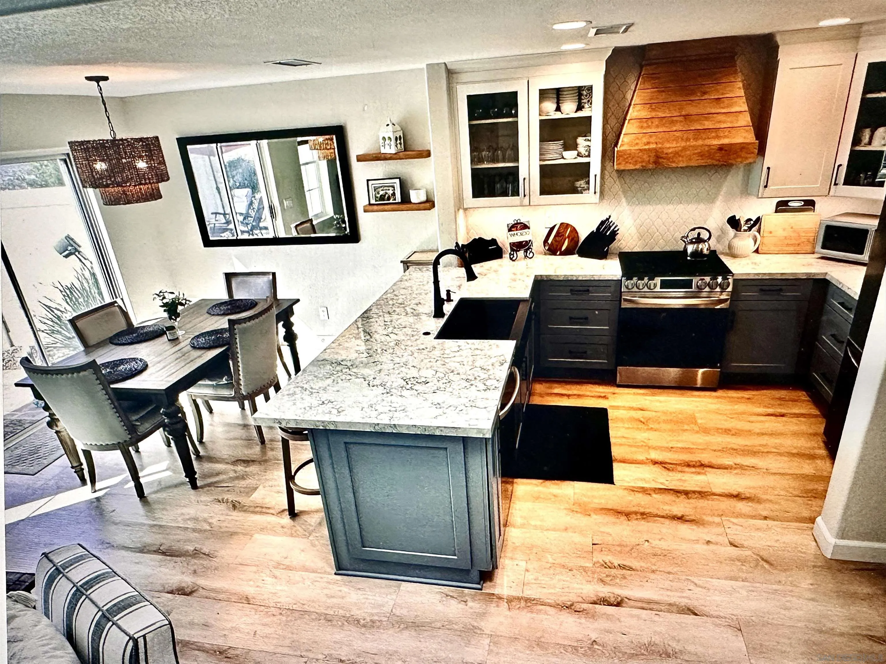 1259 Natoma Way, Unit C Oceanside, CA 92057 - Photo 17 of 52 a kitchen with a table chairs and refrigerator