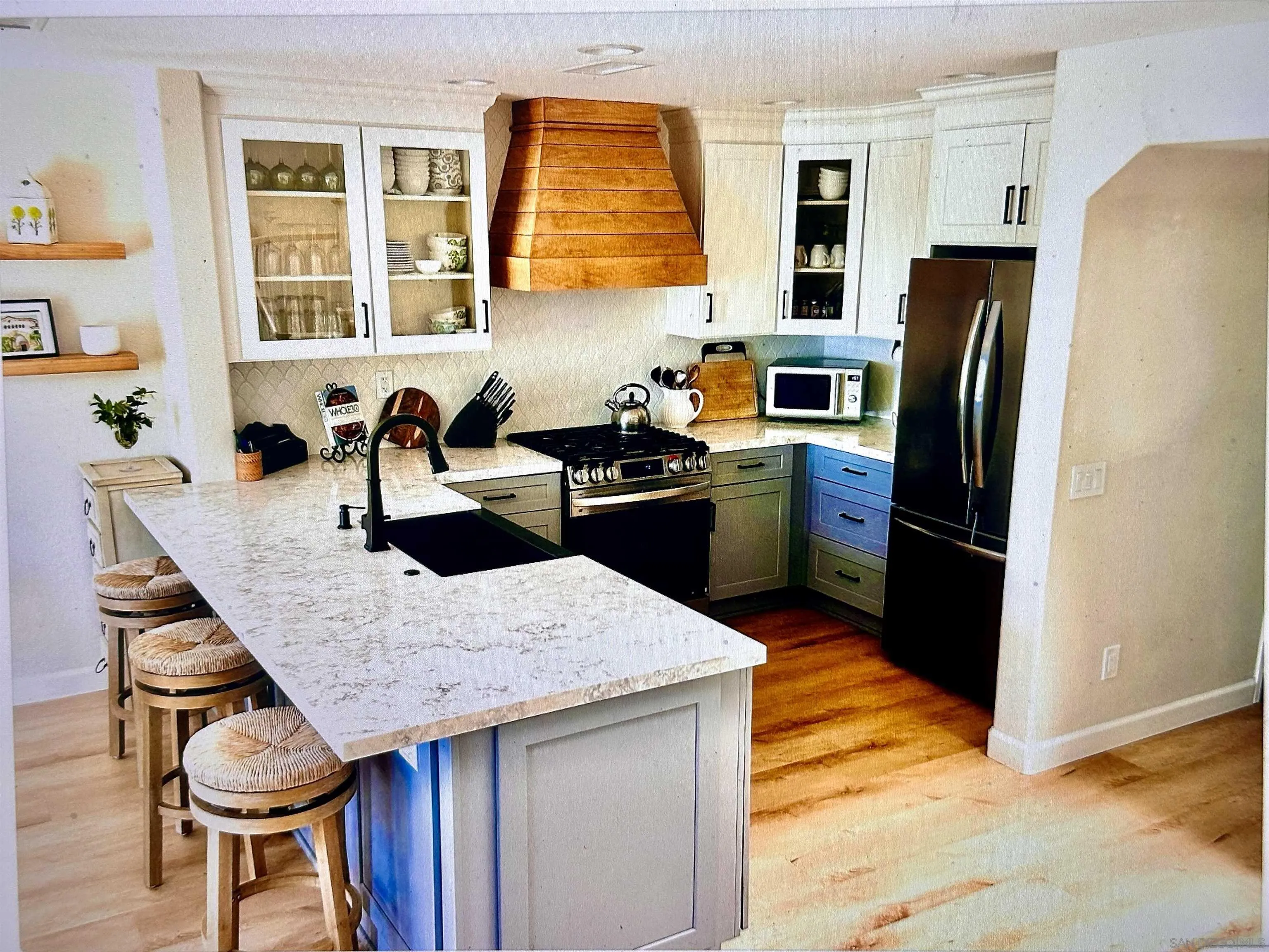 1259 Natoma Way, Unit C Oceanside, CA 92057 - Photo 18 of 52 a kitchen with a table chairs and refrigerator