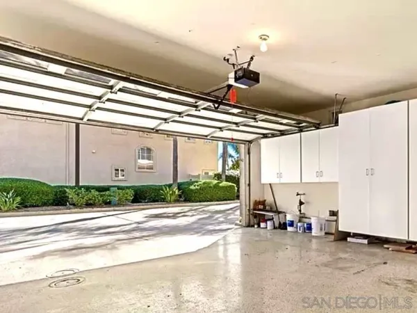 a view of a hallway to a livingroom with furniture and an empty room