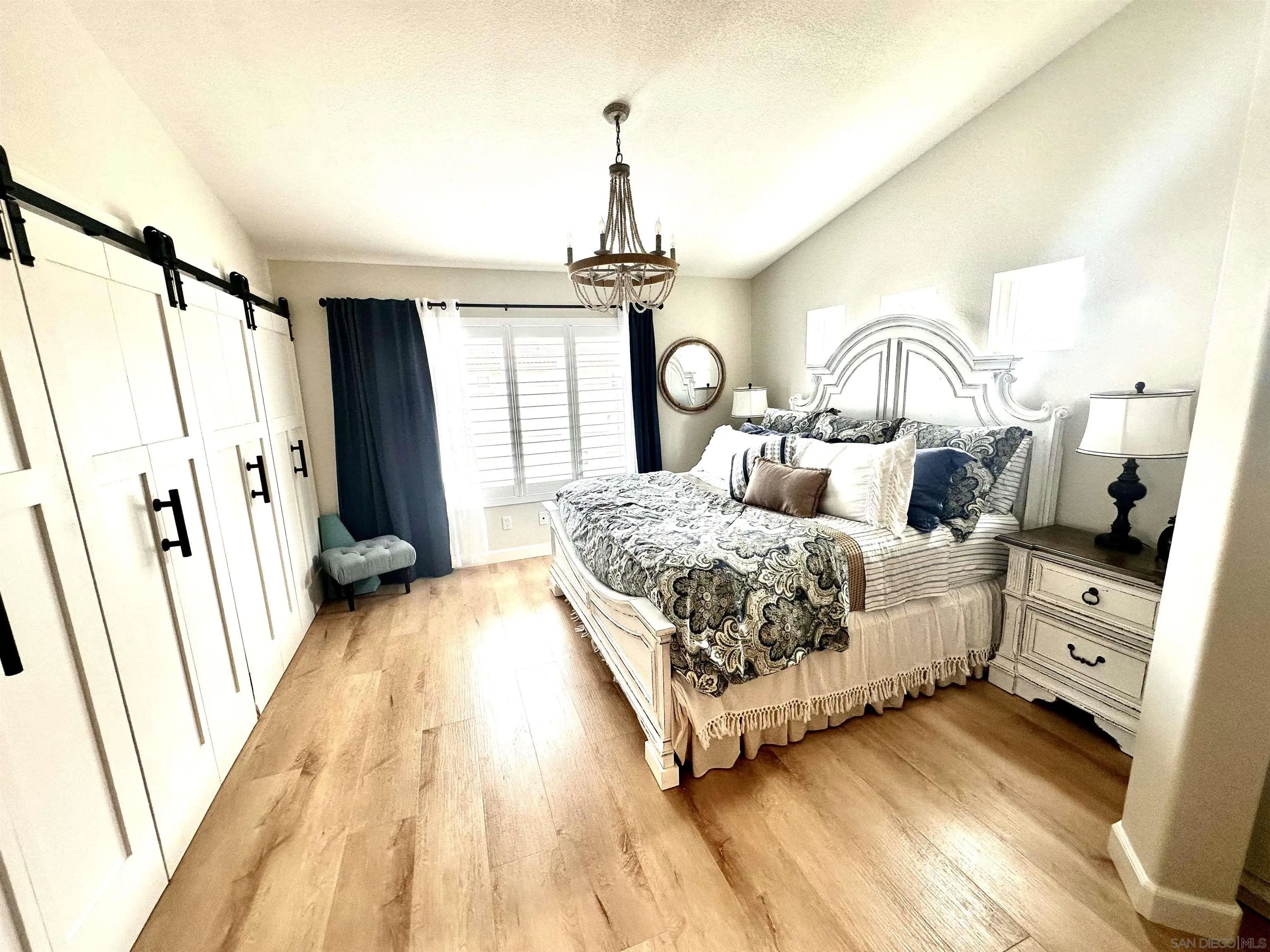1259 Natoma Way, Unit C Oceanside, CA 92057 - Photo 26 of 52 a bedroom with a bed mirror and a window
