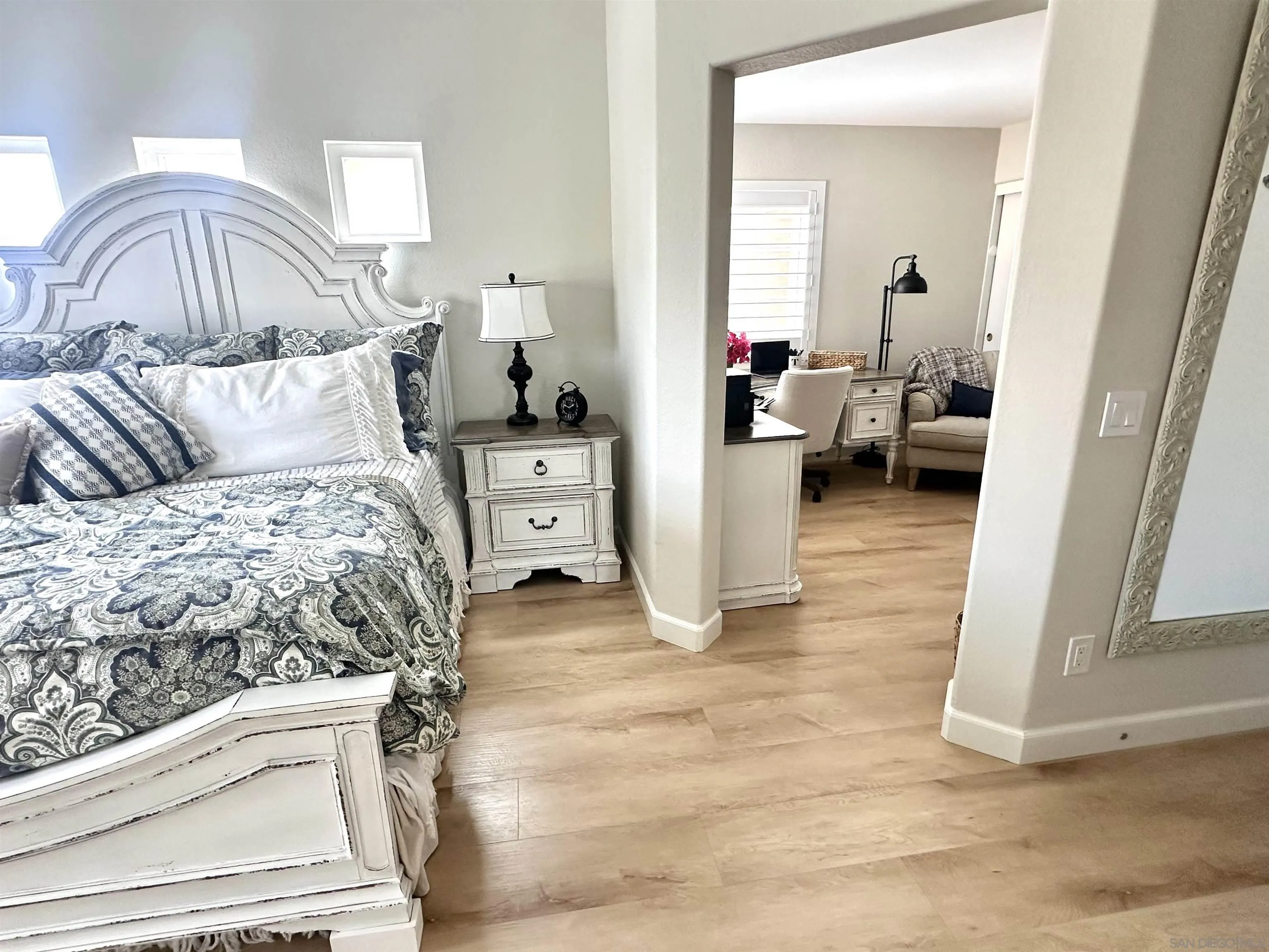 1259 Natoma Way, Unit C Oceanside, CA 92057 - Photo 29 of 52 a bedroom with a large bed and a mirror