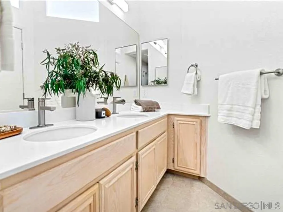 1259 Natoma Way, Unit C Oceanside, CA 92057 - Photo 33 of 52 a bathroom with a sink and a mirror