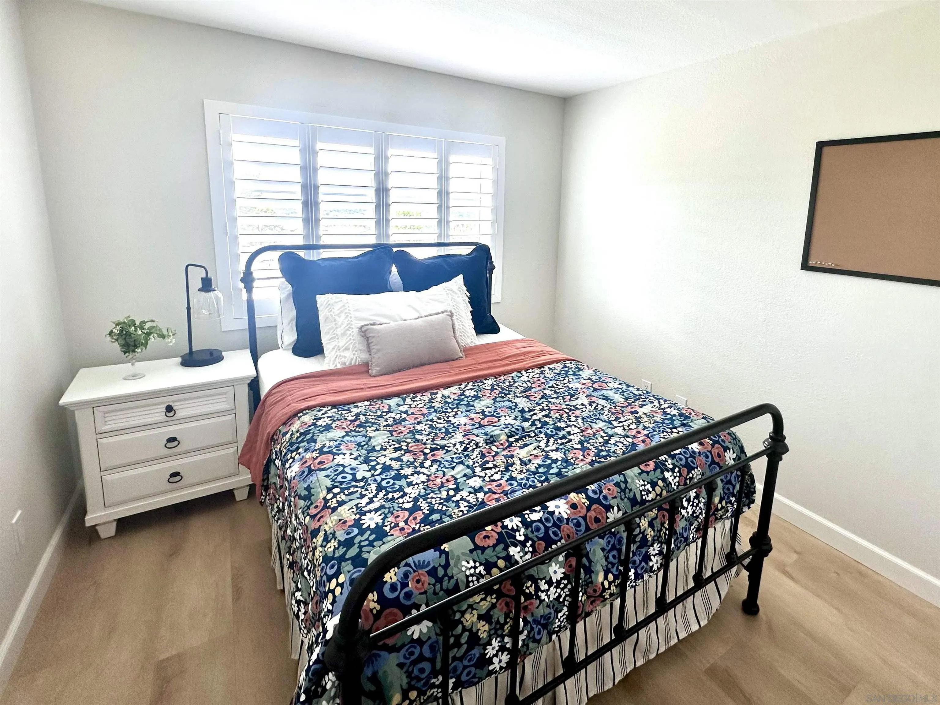 1259 Natoma Way, Unit C Oceanside, CA 92057 - Photo 35 of 52 a bedroom with a bed and a window
