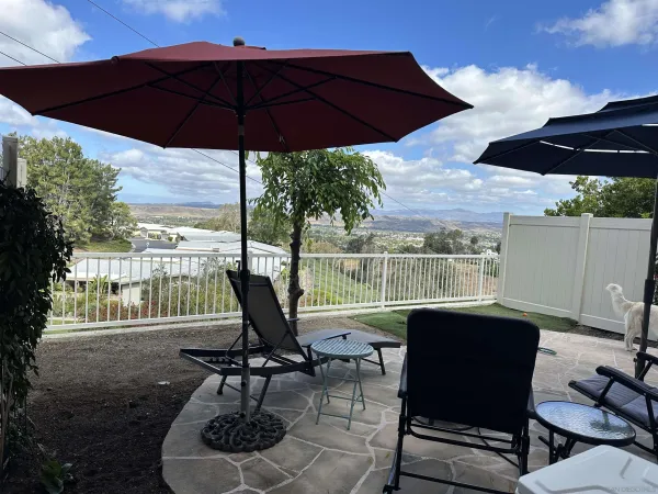 a view of a patio with a table chairs and a umbrella