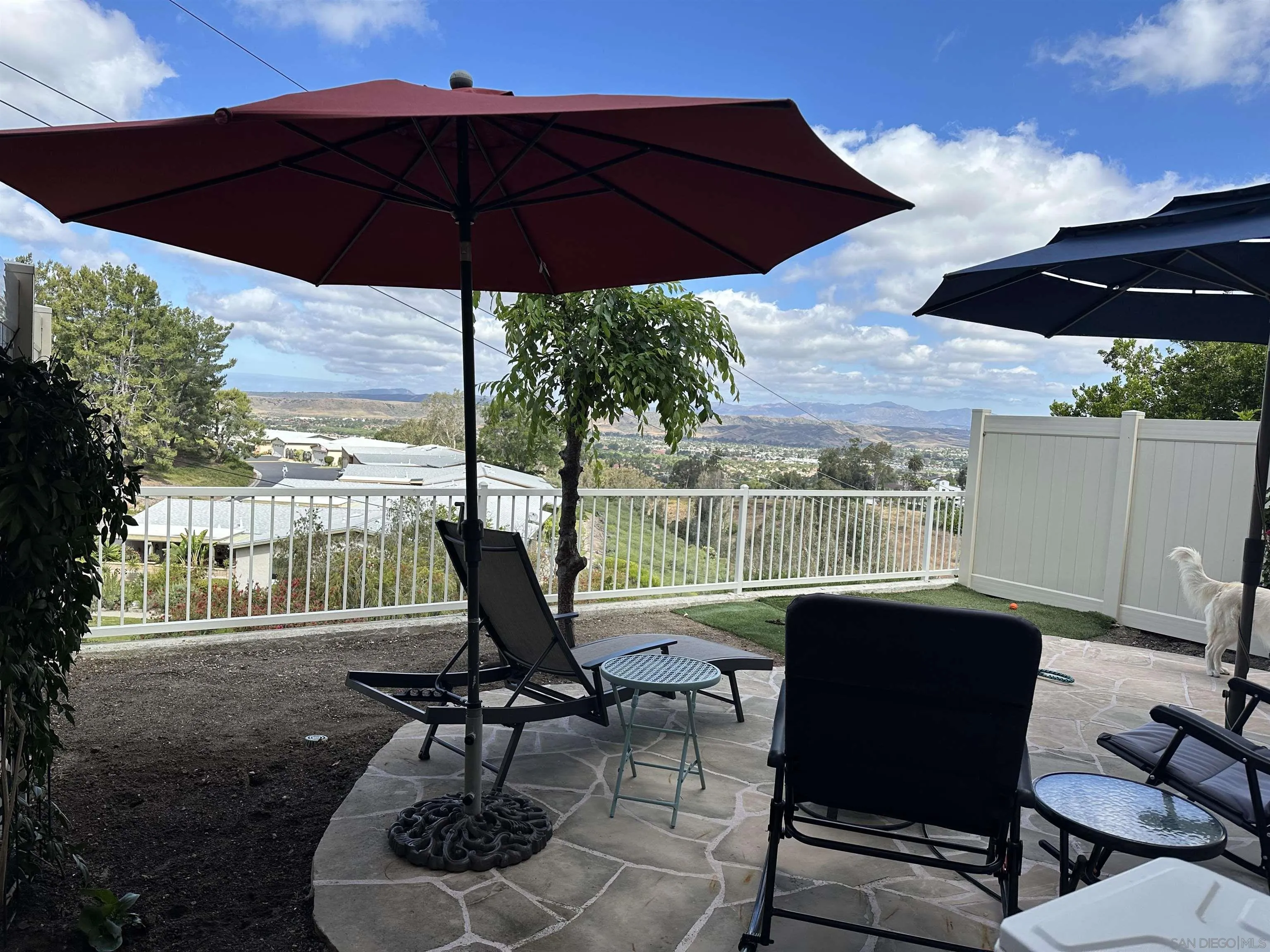 1259 Natoma Way, Unit C Oceanside, CA 92057 - Photo 5 of 52 a view of a patio with a table chairs and a umbrella