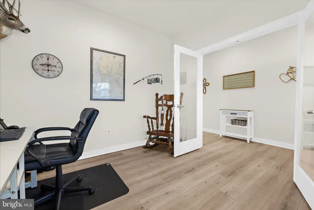 a spacious bedroom with a bed and a flat screen tv