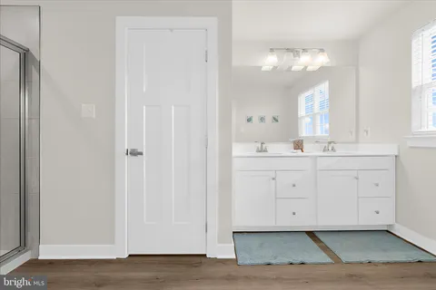 a bathroom with a glass shower door