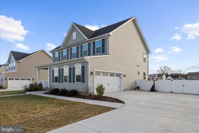 a view of a house with a swimming pool and sitting area