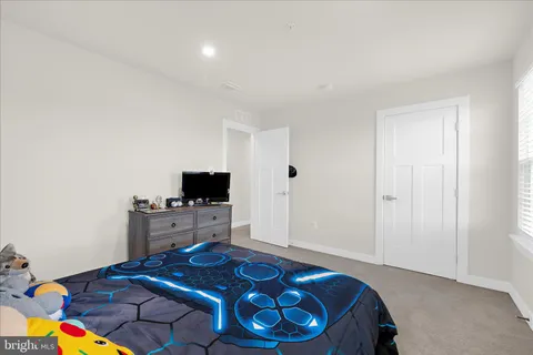 a bedroom with furniture and baby crib