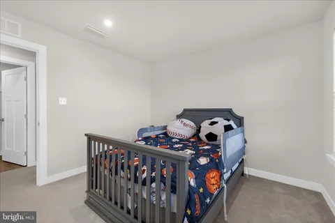 a bedroom with bed and a window