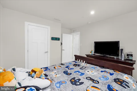 an empty room with furniture and a flat screen tv