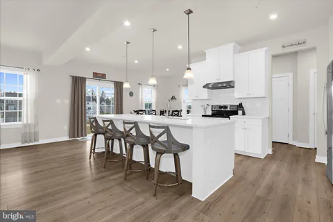 a kitchen with a microwave a stove and cabinets