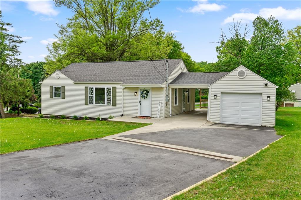 951 Shenango Road Beaver Falls, PA 15010 - Photo 1 of 25 a front view of a house with a yard and garage