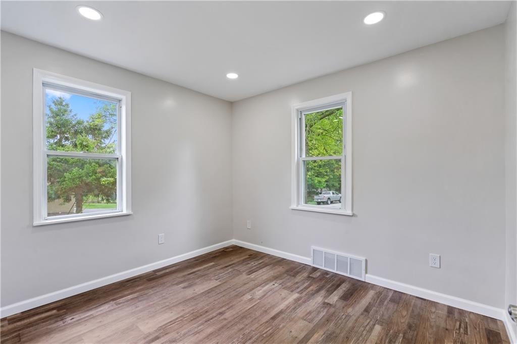 951 Shenango Road Beaver Falls, PA 15010 - Photo 14 of 25 an empty room with wooden floor and windows