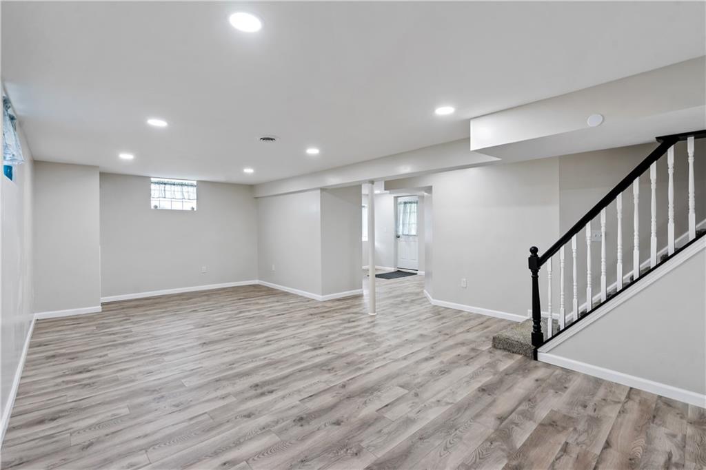 951 Shenango Road Beaver Falls, PA 15010 - Photo 16 of 25 a view of an empty room with wooden floor and stairs