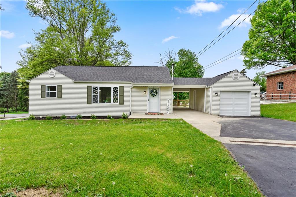 951 Shenango Road Beaver Falls, PA 15010 - Photo 2 of 25 a view of a yard in front of a house with plants and large tree